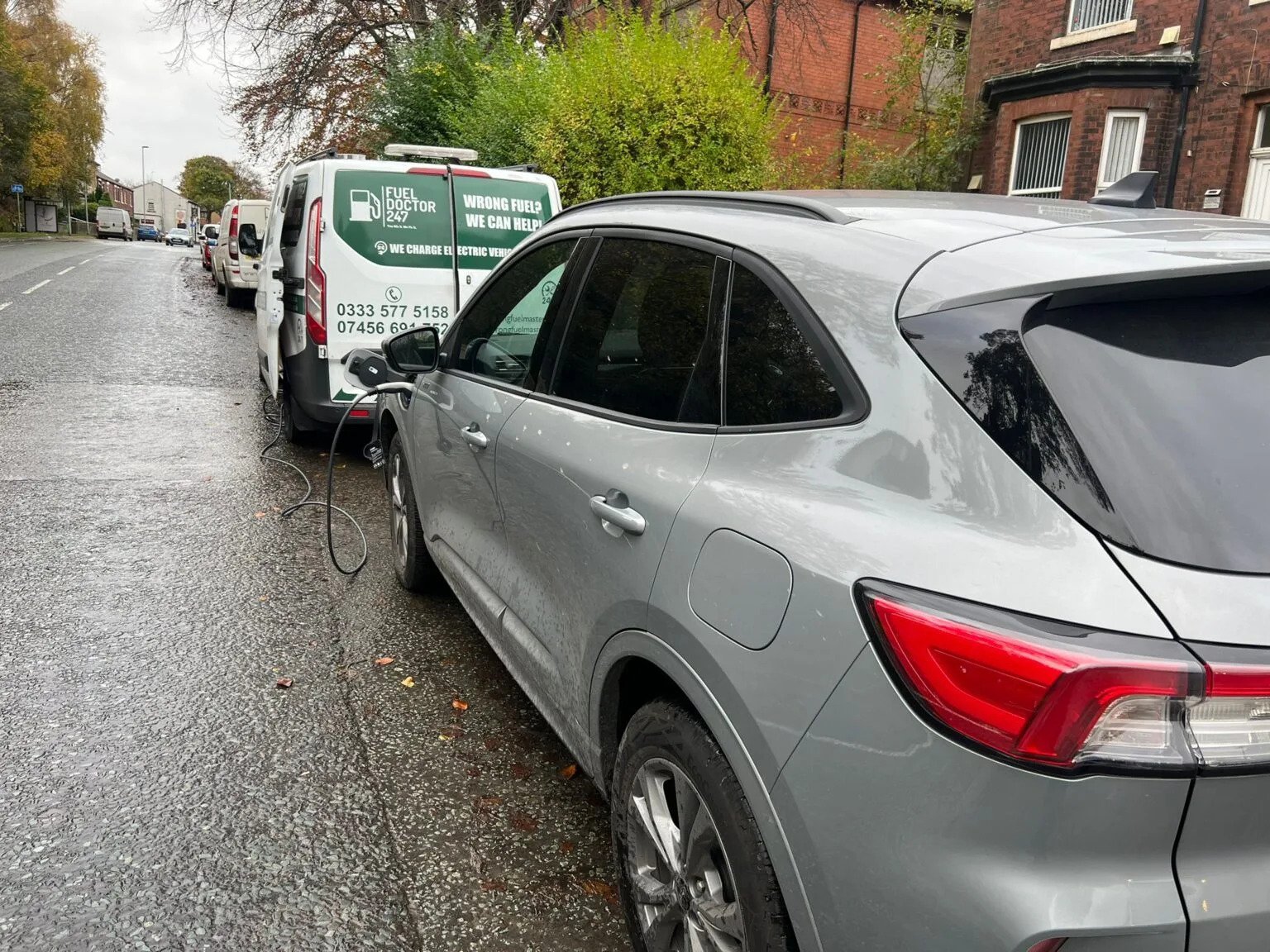 Mobile EV Charging van powering an electric car on a UK street during roadside service